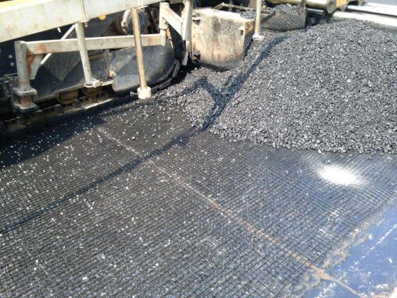 Fiberglass geogrid asphalt treatment